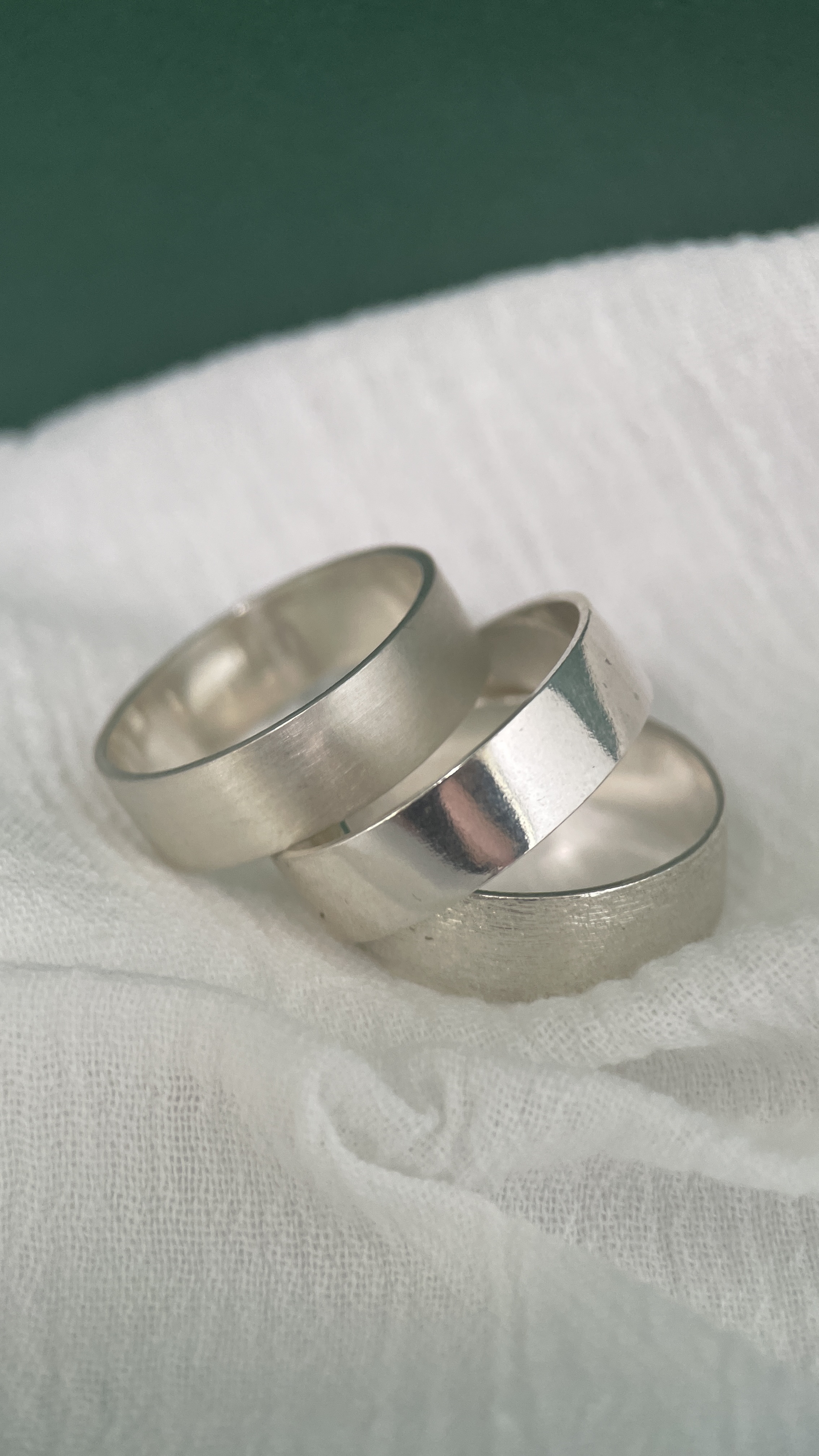 Three wide rings with different textures: matte, polished and brushed