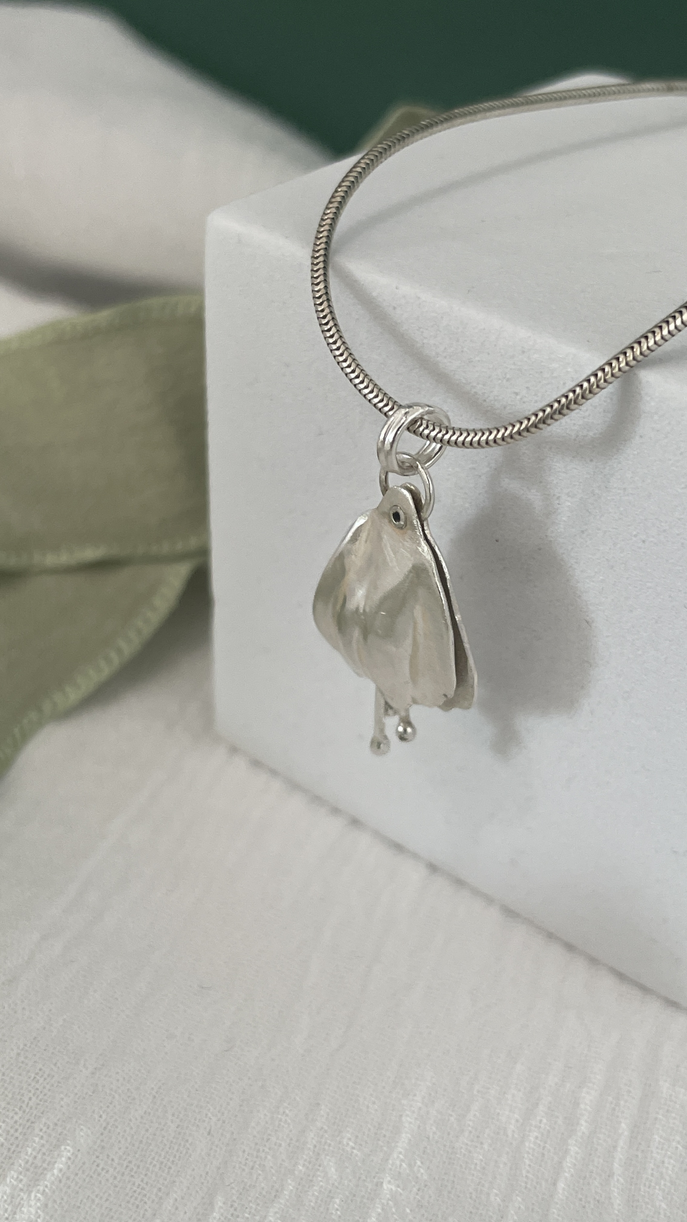 Riveted petal pendant